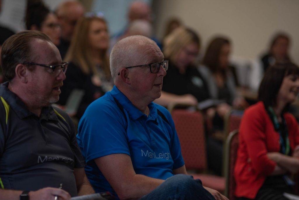 Two delegates listening from the audience at the Proper Good launch event