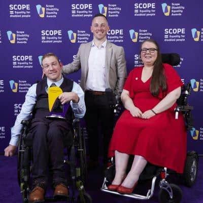 Three of the Wigan team at the Scope Disability Equality Awards, photographed against the awards backdrop