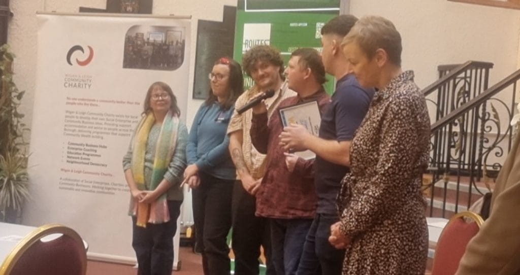 An award being presented to a group at a Wigan & Leigh Community Charity event